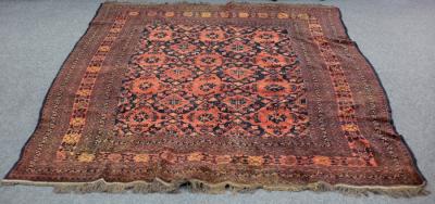 Appraisal: A Turkoman rug with red ground geometric and floral field