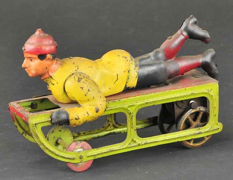 Appraisal: DAYTON BOY ON SLED Pressed steel friction driven colorful example