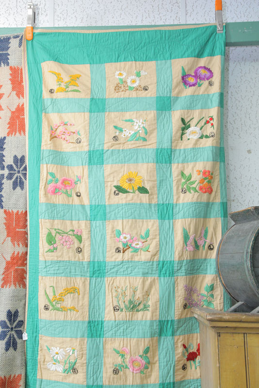 Appraisal: EMBROIDERED STATE FLOWERS QUILT Cotton quilt with green edge banding