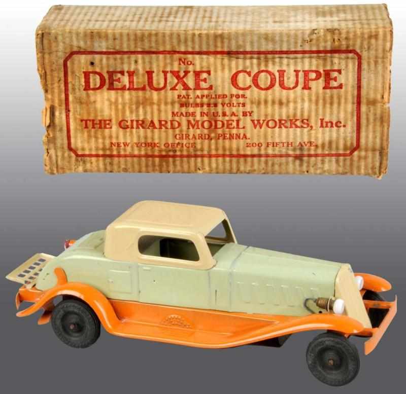 Appraisal: Pressed Steel Girard Deluxe Coupe Toy Description Wind-up mechanism is