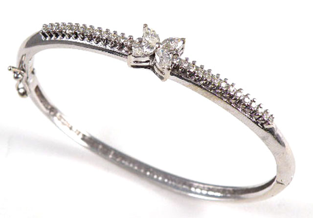 Appraisal: DIAMOND AND FOURTEEN KARAT GOLD BANGLE set with four marquise-cut