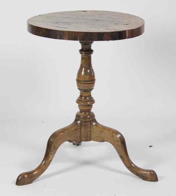 Appraisal: A marquetry tripod table the circular top inlaid with leaf