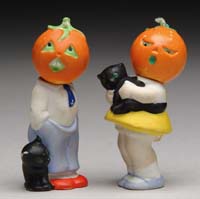 Appraisal: PAIR OF GERMAN BISQUE HALLOWEEN NODDERS Boy nodder with pumpkin