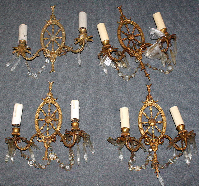 Appraisal: A SET OF FOUR GILT METAL TWO BRANCH WALL LIGHTS