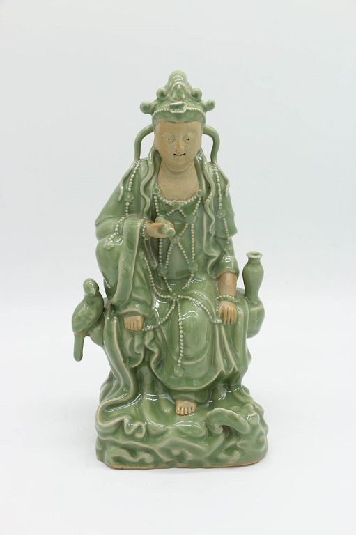 Appraisal: LONGQUAN SEATED FIGURE OF GUANYIN A celadon glazed Guanyin figure