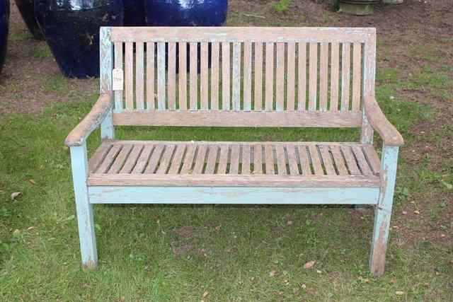 Appraisal: A TEAK GARDEN SEAT the shaped slatted back wide