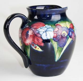 Appraisal: Moorcroft art pottery pitcher with iris floral decoration x Moorcroft