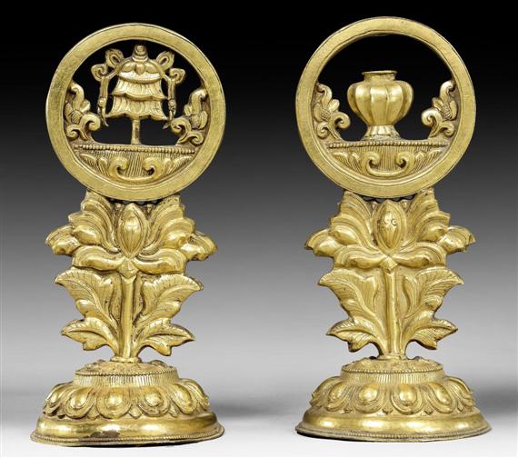 Appraisal: TWO GILT BRASS REPOUSS ALTAR EMBLEMS Eastern Tibet around height