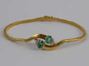 Appraisal: A yellow metal tests carat gold emerald and diamond bracelet