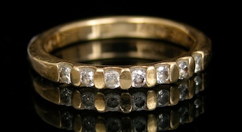 Appraisal: A Gold Band with Diamonds k yellow gold band features