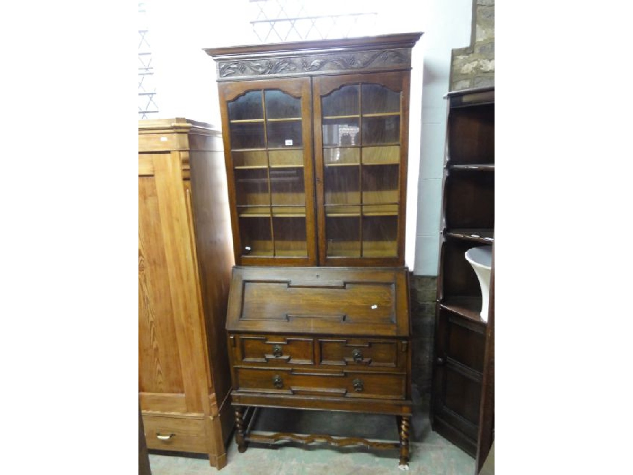 Appraisal: An Edwardian 's Jacobean revival oak bureau bookcase the upper