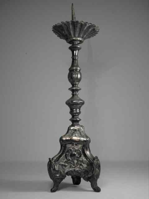 Appraisal: A th century altar candlestick with a heavily embossed metal