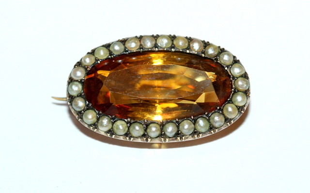 Appraisal: A VICTORIAN OVAL CITRINE AND PEARL BROOCH central facetted stone