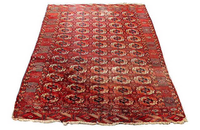 Appraisal: AN ANTIQUE RED GROUND BOKHARA RUG the central field decorated