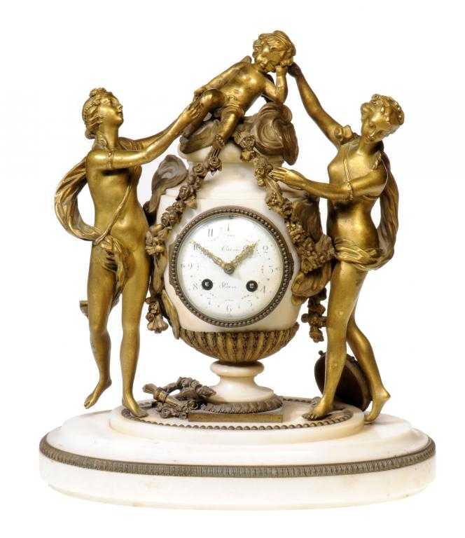 Appraisal: A FRENCH GILT BRONZE AND STATUARY MARBLE CLOCK signed on