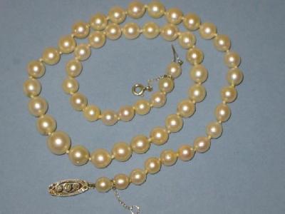 Appraisal: A CULTURED PEARL NECKLACE the mildly graduated pearls having diamond