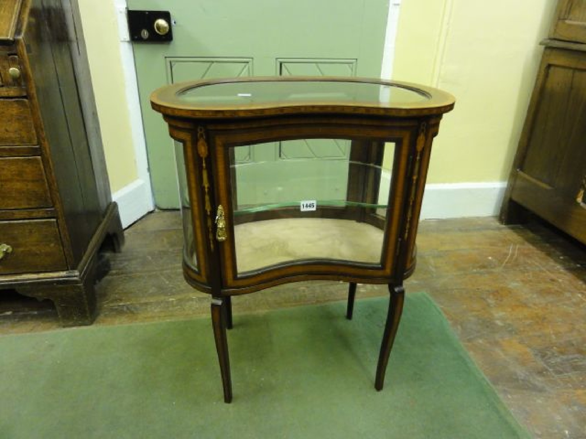 Appraisal: An inlaid Edwardian mahogany freestanding kidney shaped vitrine with satinwood