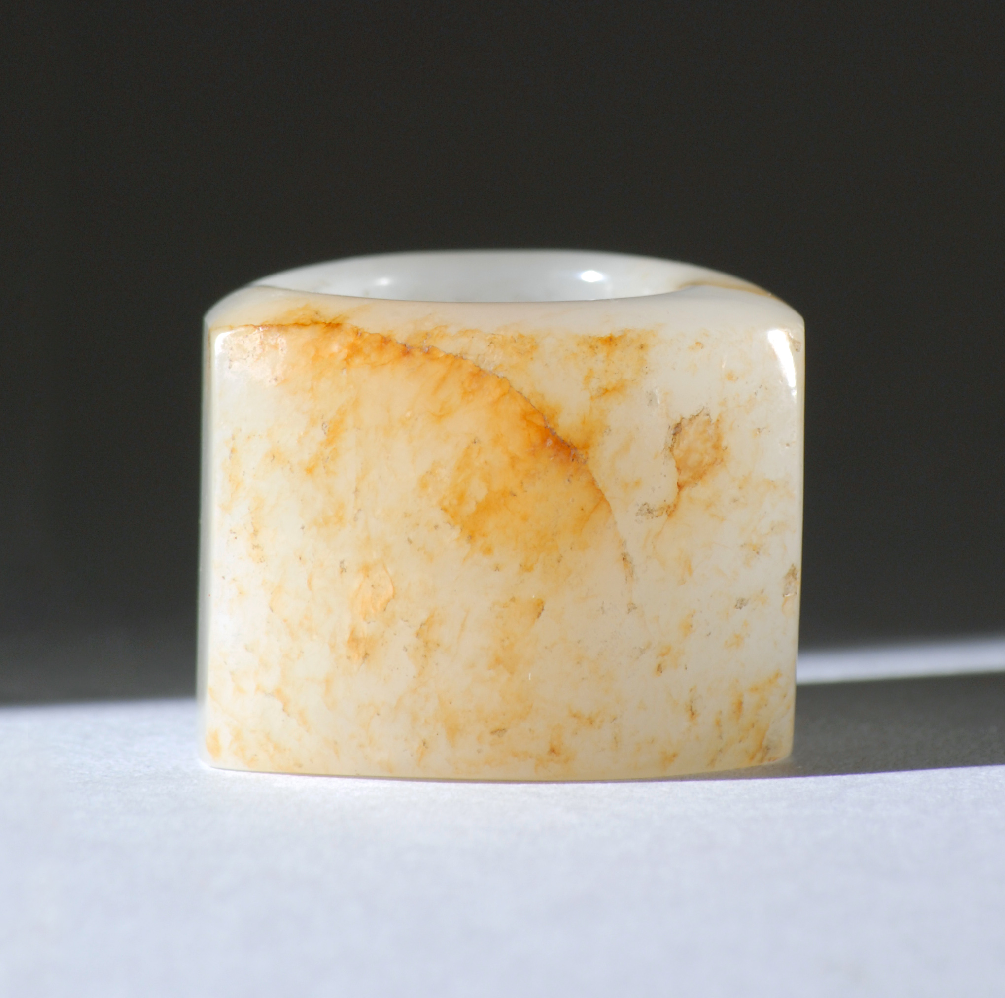 Appraisal: WHITE JADE ARCHER'S RING th CenturyWith flattened russet area using