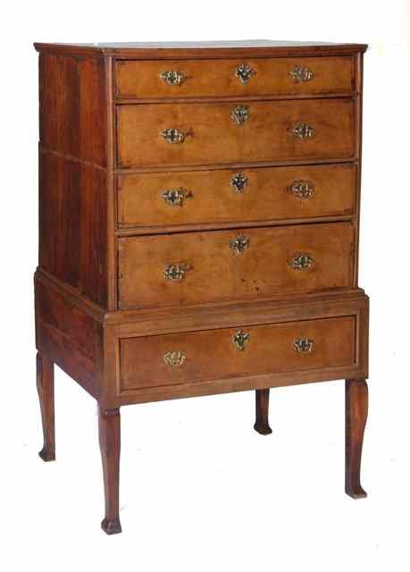 Appraisal: AN TH CENTURY WALNUT CHEST on stand fitted four graduated