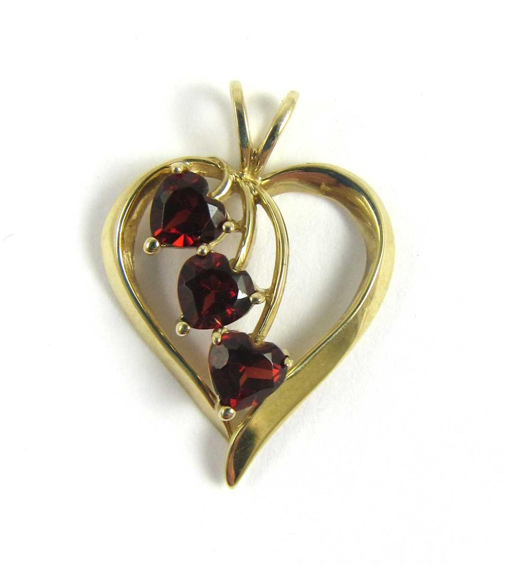 Appraisal: GARNET AND YELLOW GOLD OPEN HEART PENDANT The k yellow