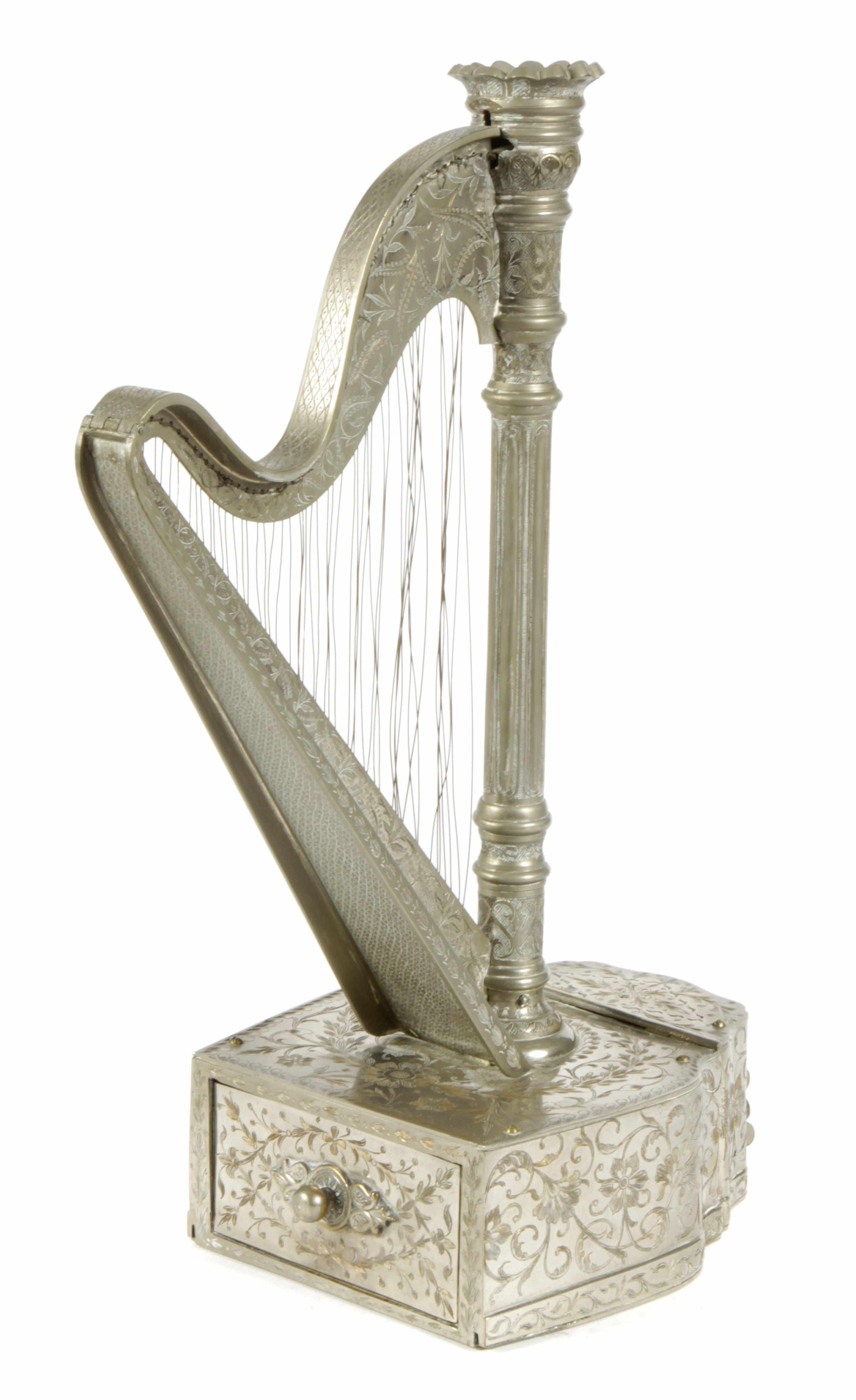 Appraisal: A Continental engraved metal music box Surmounted by a harp