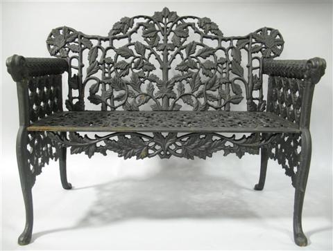 Appraisal: BLACK PAINTED WROUGHT IRON GARDEN BENCH th century the shaped