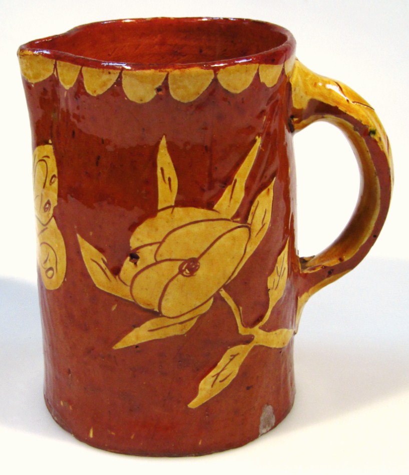 Appraisal: An early thC slipware jug with moulded beak spout and