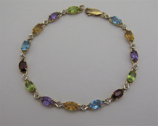 Appraisal: MULTI-COLOR GEMSTONE AND KARAT GOLD BRACELET in length with peridots