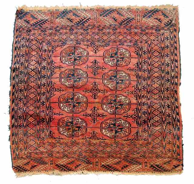 Appraisal: A TEKKE PALE RED GROUND RUG decorated two rows of