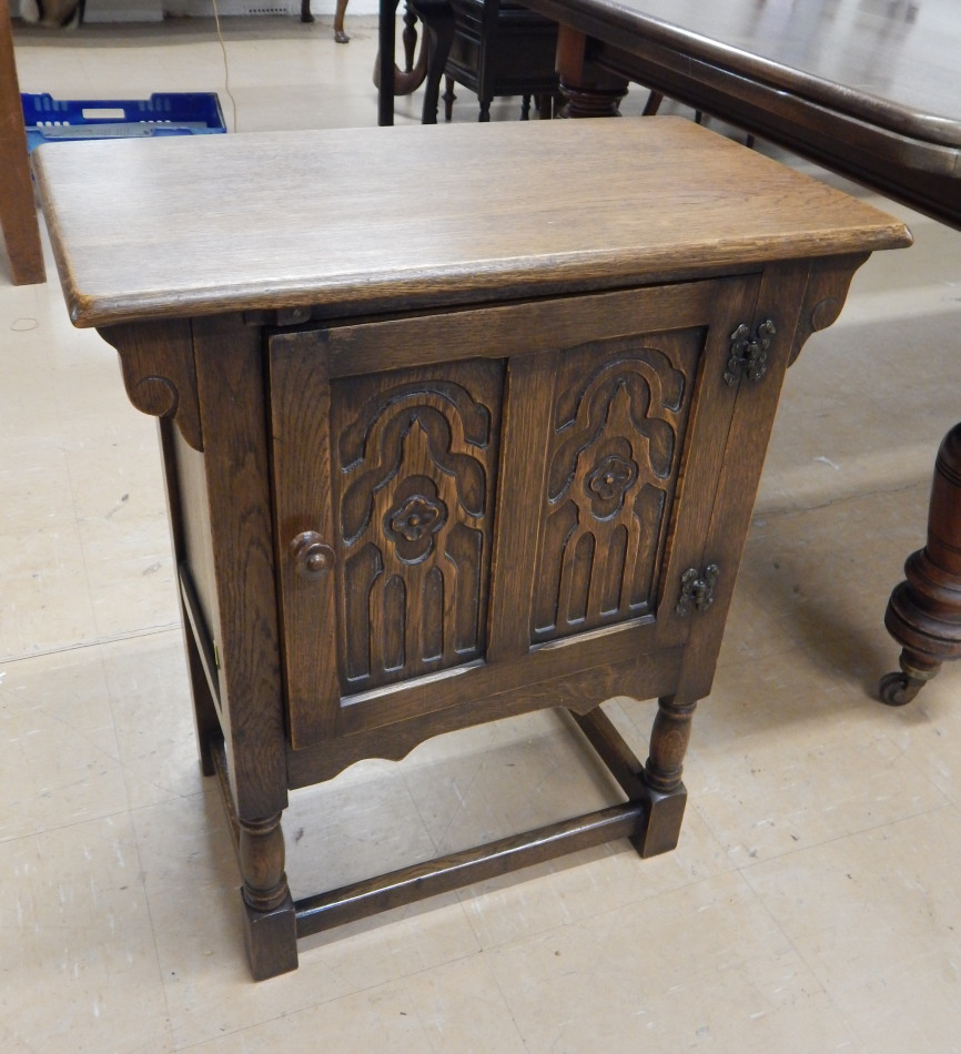 Appraisal: A thC Gothic carved oak side cabinet with a single