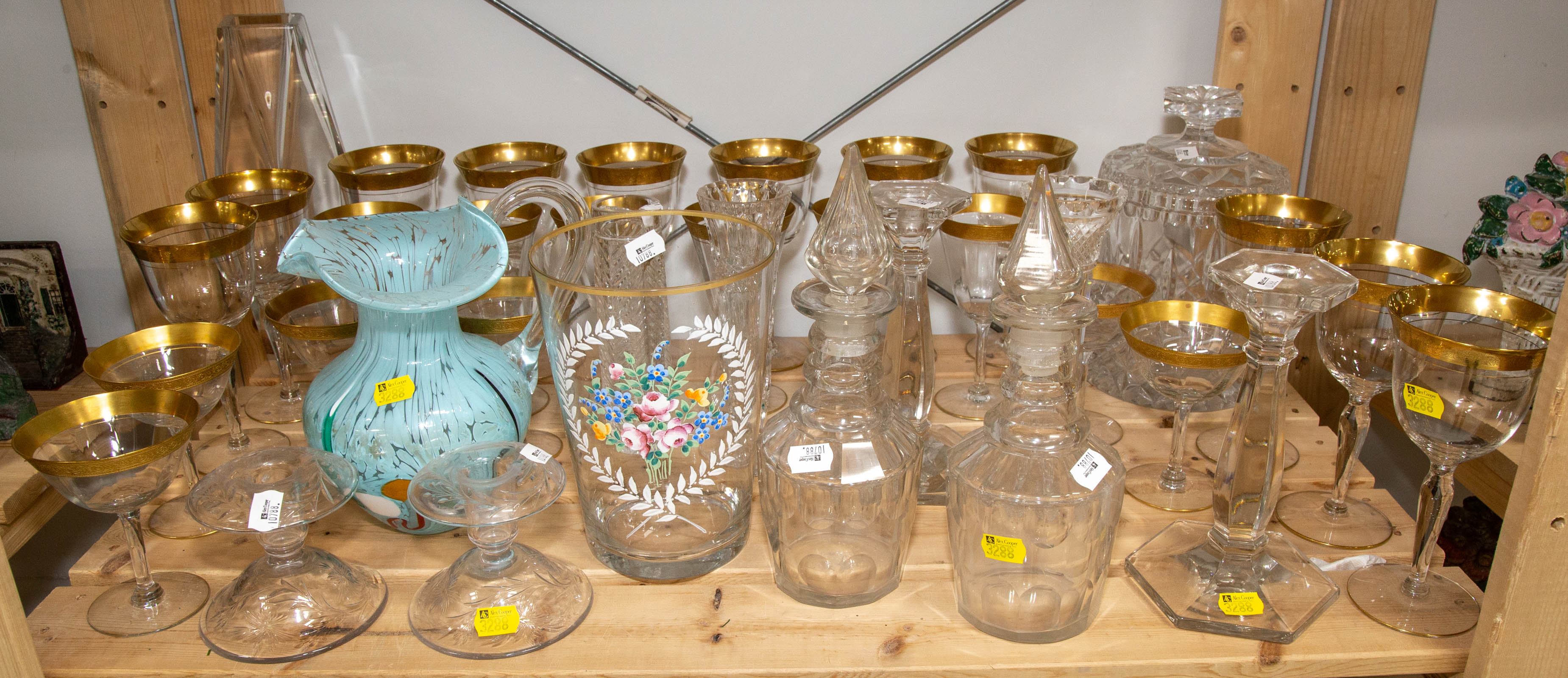 Appraisal: A SHELF OF ASSORTED GLASSWARE Includes two decanters in H