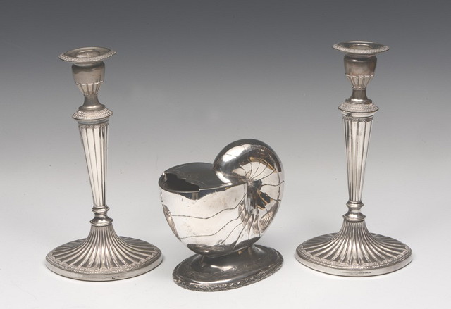 Appraisal: A PAIR OF ADAM STYLE SILVER PLATED CANDLESTICKS of fluted