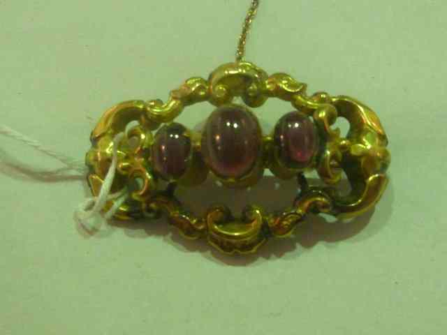 Appraisal: A VICTORIAN BAR BROOCH of stylised form with cabochon setting