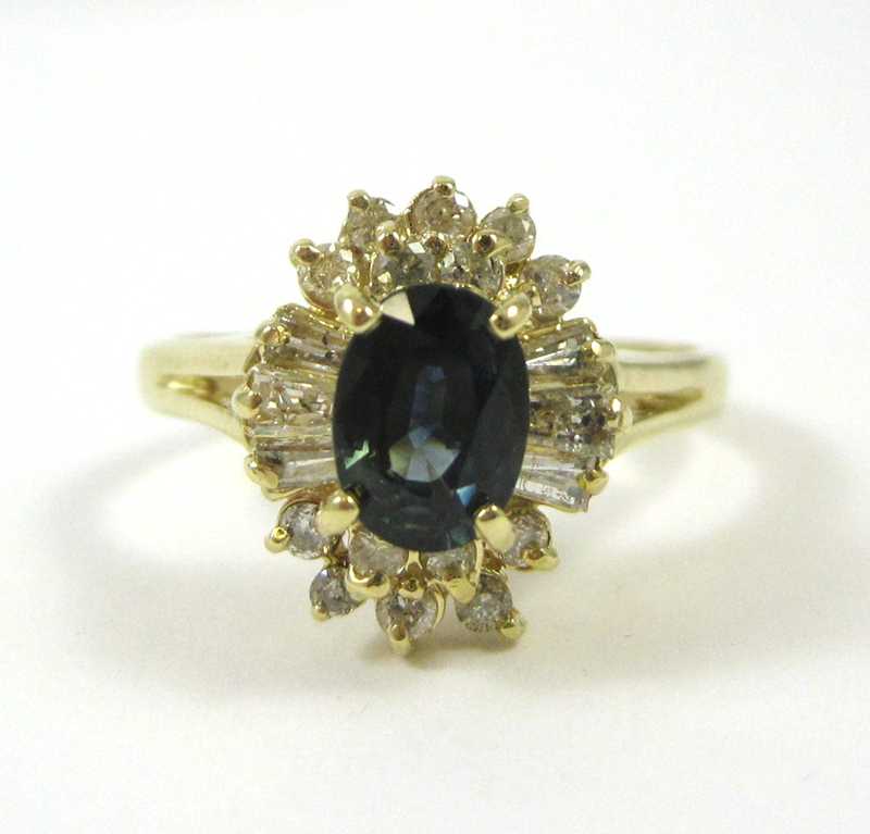 Appraisal: FOURTEEN KARAT GOLD SAPPHIRE AND DIAMOND RING the oval-cut sapphire