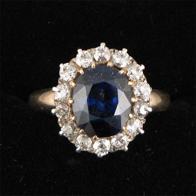 Appraisal: A sapphire and diamond cluster ring the oval shaped sapphire