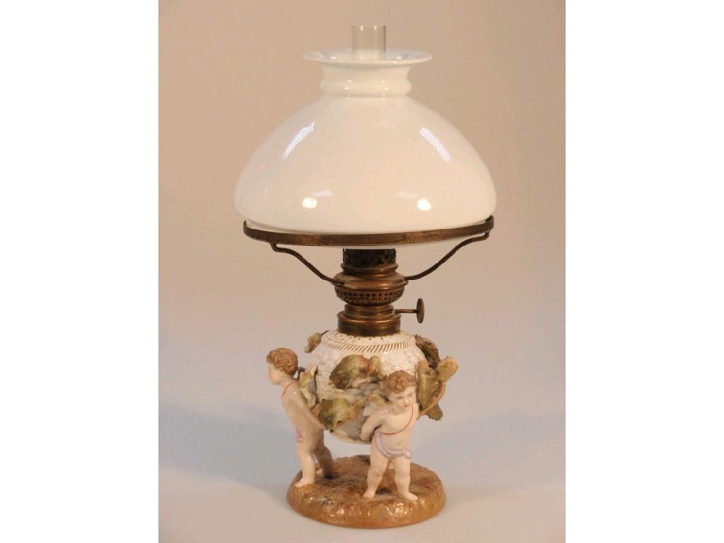 Appraisal: A thC Sitzendorf table lamp with three cherubs supporting a