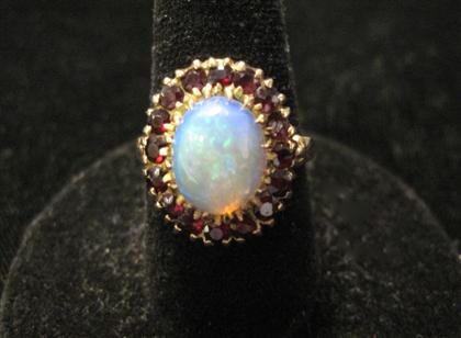 Appraisal: karat yellow gold opal and garnet ringOval opal framed by