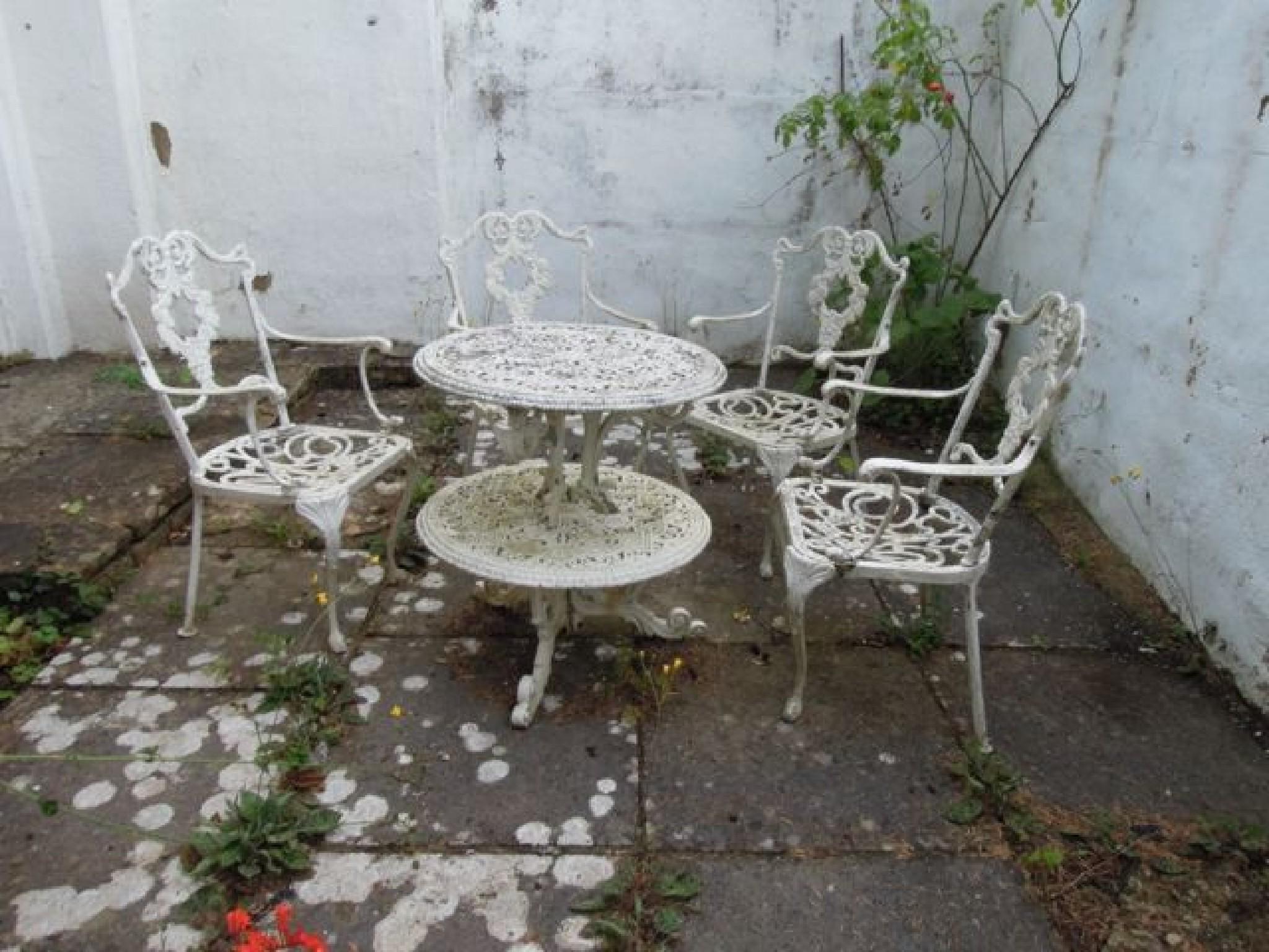 Appraisal: A cast aluminium two tier garden table and four chairs