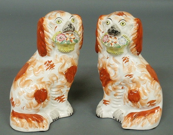 Appraisal: Pair of English Staffordshire seated spaniels c with yellow eyes