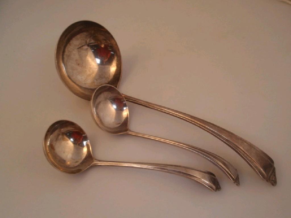 Appraisal: A suite of three Art Deco silver ladles Birmingham oz