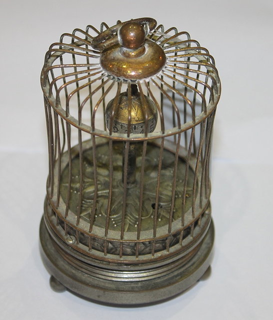 Appraisal: AN EDWARDIAN AUTOMATON in the form of a bird cage