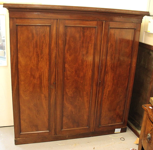 Appraisal: A VICTORIAN MAHOGANY TRIPLE WARDROBE with panelled doors two of