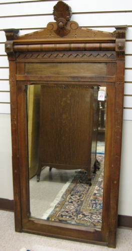 Appraisal: A VICTORIAN WALNUT-FRAMED WALL MIRROR Eastlake design American last quarter