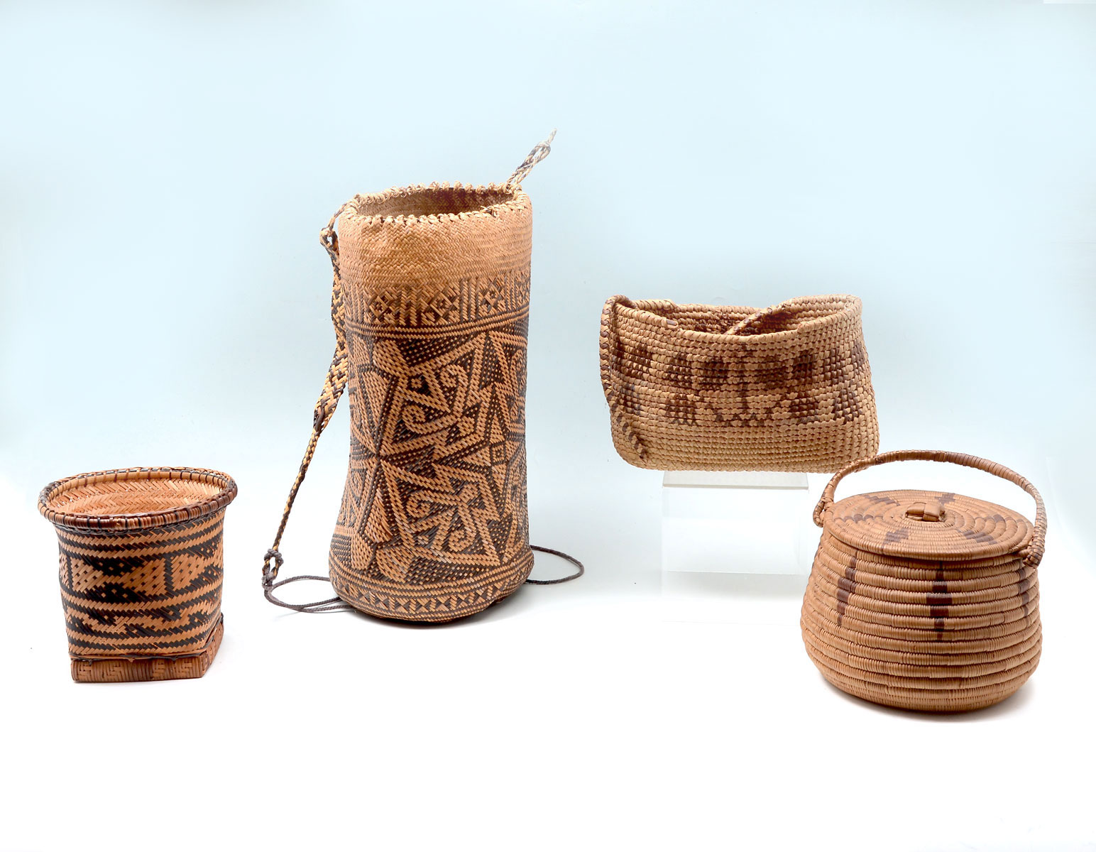 Appraisal: PC NATIVE INDIAN WOVEN BASKETS Comprising lidded handled basket backpack