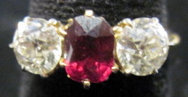 Appraisal: Yellow gold ruby and diamond ring Center round ruby flanked