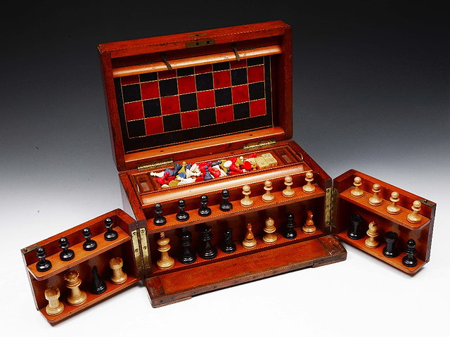 Appraisal: A VICTORIAN MAHOGANY GAMES COMPENDIUM with chess pieces dice etc