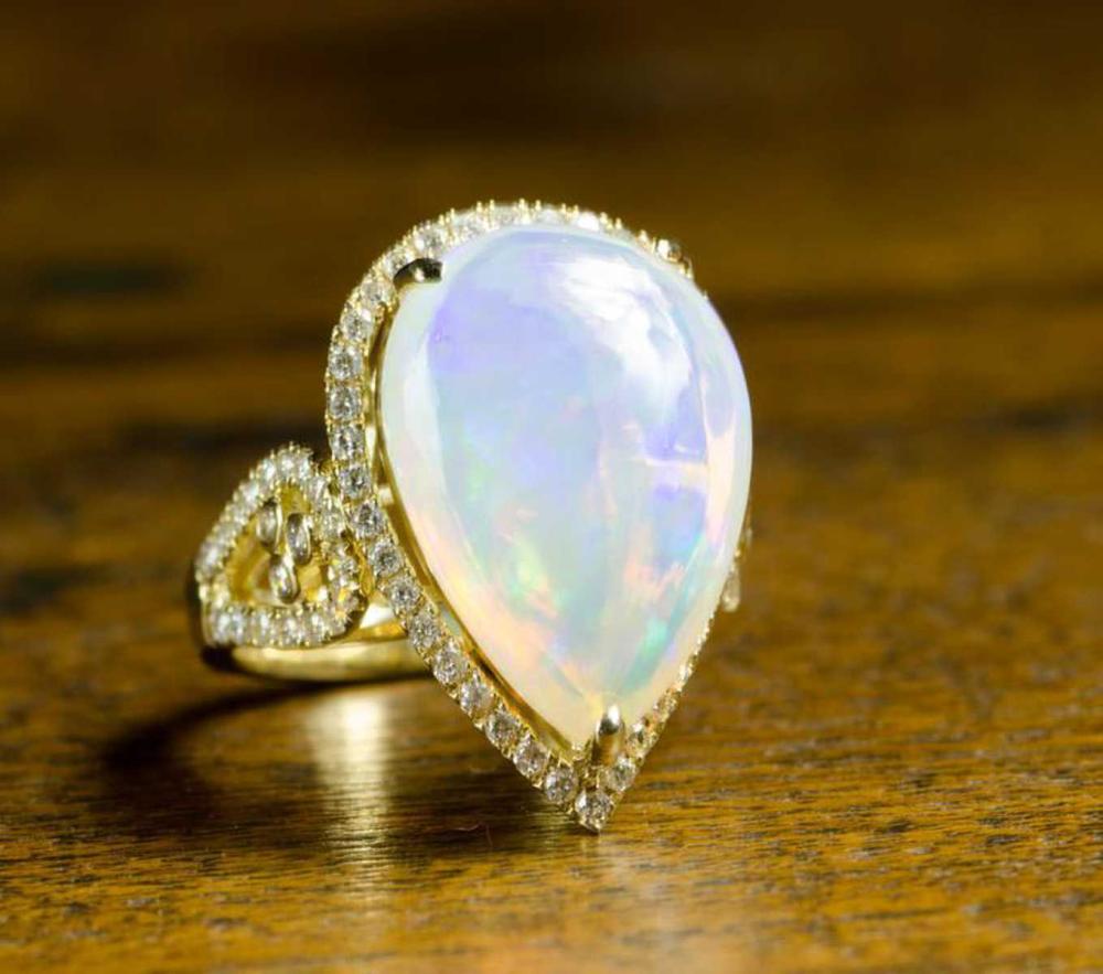 Appraisal: OPAL DIAMOND AND FOURTEEN KARAT GOLD RING with round-cut diamond