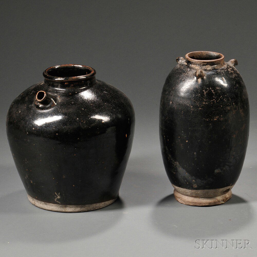 Appraisal: Two Black-glazed Jars China both oviform resting on a short