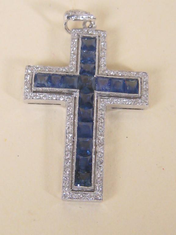 Appraisal: A sapphire and diamond Cross pave set sixteen cushion shaped