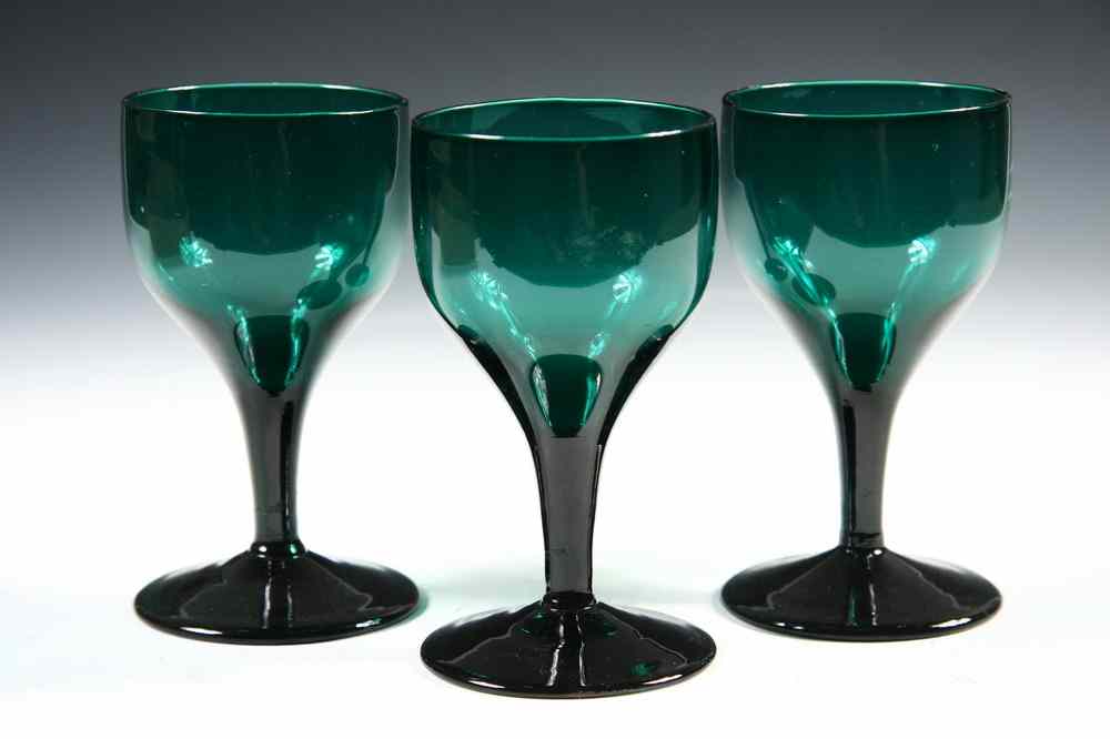 Appraisal: COLONIAL GLASS GOBLETS - Three Blown Green Glass Goblets with